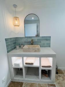 a bathroom with a sink and a mirror at Petit cocon provençal à 2mn d'Arles in Fourques +4 photos