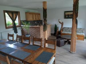 a living room with a table and a fireplace at Vilmos Vendégház in Vărşag