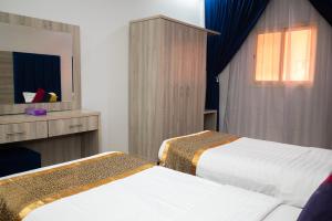 Postel nebo postele na pokoji v ubytování شقق أهلين للشقق المخدومة + 22 fotografií