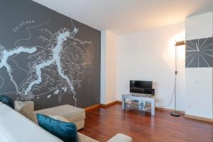 a living room with a wall with a map on it at Large well-equipped appartement near Como lake in Lecco