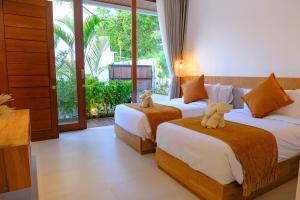 Postel nebo postele na pokoji v ubytování Villa Moon Orchid - 3 bedroom villa + 47 fotografií