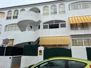 a yellow car parked in front of a building at La Laguna del Portil in El Portil