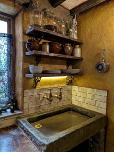 a kitchen with a stone sink in a room at Witchcraft and Wizardry - York in York