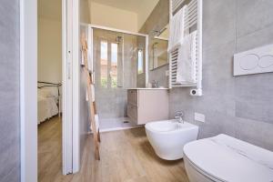 a bathroom with a white toilet and a sink at B&B VillaPrimavera in Porto San Giorgio +28 photos