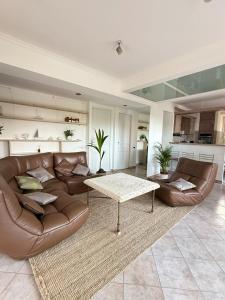 a living room with a couch and a table at Cozy Villa Saint-Jean-Cap-Ferrat in Saint-Jean-Cap-Ferrat