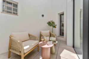 a room with a chair and a table with wine glasses at Casa Portixol Playa in Palma de Mallorca