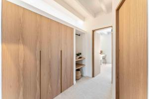 a hallway with wood panels and a door at Casa Portixol Playa in Palma de Mallorca