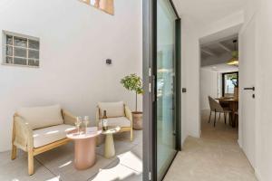 a living room with a couch and a table at Casa Portixol Playa in Palma de Mallorca +11 photos
