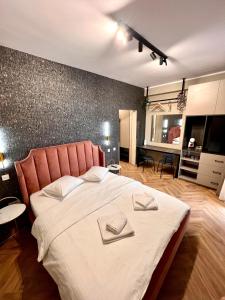 a bedroom with a large bed with two napkins on it at MK Apart Boutique 2 in Voluntari