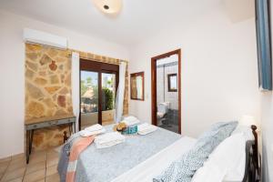 a bedroom with a bed and a large window at Villa Pasiphae 2 in Stalos +38 photos