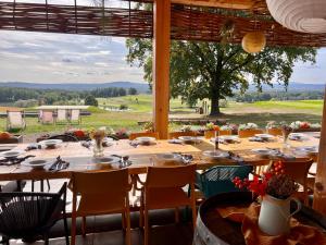 a dining room with a table and a large window at Na Golfu in Kestřany