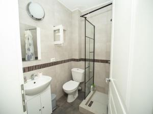 a bathroom with a toilet and a sink and a mirror at Central house in Iaşi