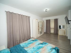 a bedroom with a bed in the middle of a room at Central house in Iaşi