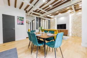 a dining room with a table and chairs at Bridgestreet Le Marais - les halles - Republique in Paris