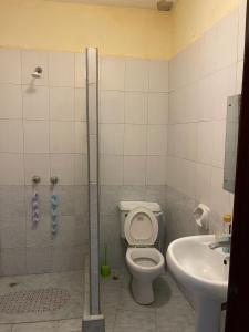 a bathroom with a toilet and a sink at Nyali Sunrise Apartment in Nyali +10 photos