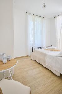a white bedroom with a bed and a table at B&B VillaPrimavera in Porto San Giorgio +29 photos