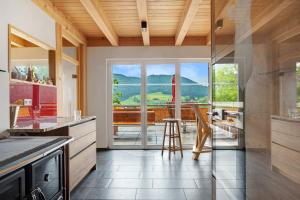 a kitchen with a view of a table and chairs at Schonzeit Chalet in Bernau im Schwarzwald