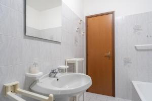 a white bathroom with a sink and a mirror at Lecco Incanto in Lecco +18 photos