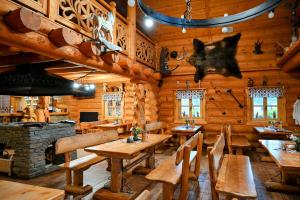 a dining room with wooden tables and a fireplace at Zbojnicky penzion in Jasenica +70 photos
