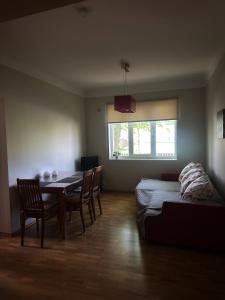 a room with a table and chairs and a bed at Janno apartment in Pärnu