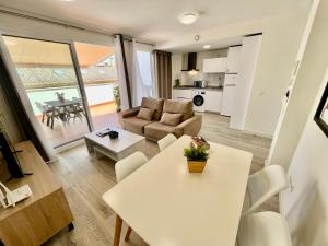 a living room with a table and a couch at Apartamentos Rincón del Mar in Torre del Mar