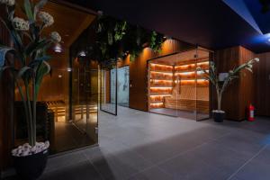 a lobby of a building with plants and lights at Bliss Palace Hotel & Spa in Skopje
