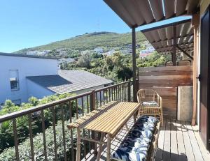 a wooden bench on the balcony of a house at Grand Studio dans Residence avec piscine in Sisco in Sisco