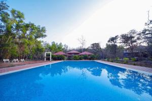 a swimming pool with blue water in a resort at Dream Valley resort in Dandeli