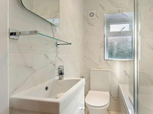 a white bathroom with a sink and a toilet at 2 Bed in Grassington 93941 in Hebden +12 photos