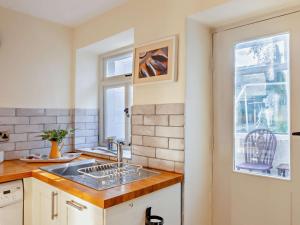 a kitchen with a sink and a window at 2 Bed in Grassington 93941 in Hebden +32 photos