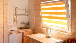 a small kitchen with a sink and a window at VacationClub - Madamaku VacationHome 37 in Sianozety