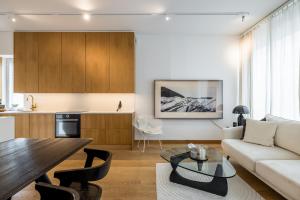 a living room with a couch and a table at Scandinavian Deluxe House With Private Sauna at Kamppi in Helsinki