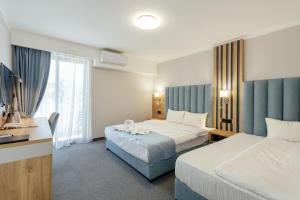 Postel nebo postele na pokoji v ubytování HOTEL TALIA
