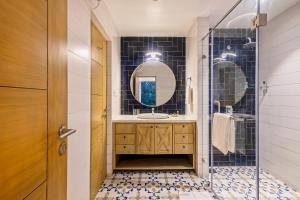 a bathroom with a sink and a mirror at Brand New Luxury 1BHK Apartment by tisyastays in Candolim +8 photos