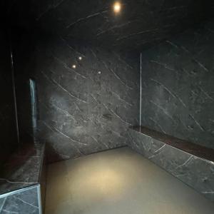 una stanza con una parete di marmo nero con una luce accesa di Beresford Cottage a Skegness