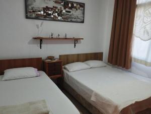 Postelja oz. postelje v sobi nastanitve Lily Guest House with Amazing View House with Garden