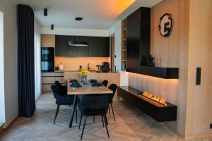 a kitchen and dining room with a table and chairs at Lux Penthouse with sauna in Rakvere