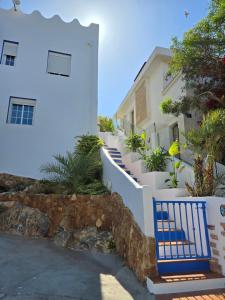 a blue bench in front of a white building at La cueva inès in Almería