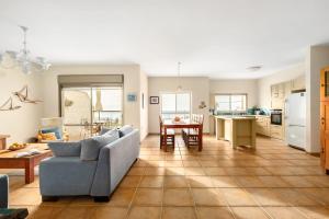 a living room and kitchen with a couch and a table at Nahariya Beachside Comfort Stay by Sea N Rent in Nahariyya