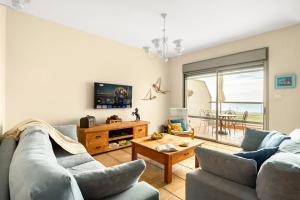 a living room with two couches and a table at Nahariya Beachside Comfort Stay by Sea N Rent in Nahariyya
