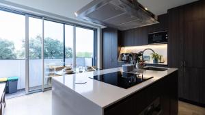a kitchen with a white counter top and a large window at Fantastic Alda Rodrigues Apartment by Unique Hosts in Senhora da Hora