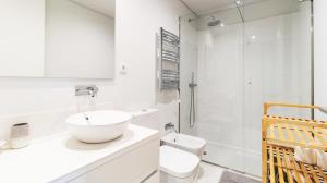a bathroom with a sink and a toilet and a shower at Fantastic Alda Rodrigues Apartment by Unique Hosts in Senhora da Hora +26 photos