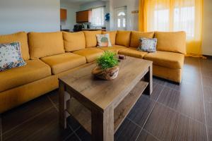 a living room with a couch and a coffee table at Villa PAPADATES NEFELI in Barbaliáki