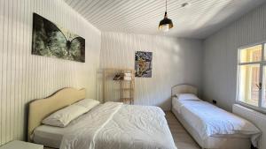 a bedroom with two beds and a window at Lavera Home Uzungöl in Uzungöl