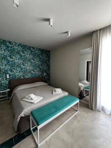 a bedroom with a bed with a green accent wall at Attico Terrammare in Trapani