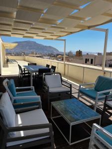 a patio with chairs and tables on a roof at Attico Terrammare in Trapani