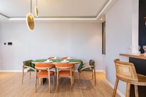 a dining room with a table and chairs at Volaire Luxury 2-Bedroom, Rooftop Swimming Pool, Gym, Workspace - Wonderiss Homes Westlands Living in Nairobi
