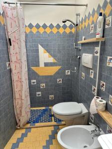 a bathroom with a shower and a toilet and a sink at Appartamento Nuvola Bianca 2 in Cesenatico +16 photos