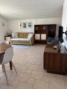 a living room with a couch and a table at Appartamento Nuvola Bianca 2 in Cesenatico