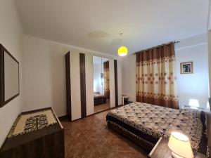 a bedroom with a bed and a large mirror at DUE PASSI dal MARE in Cittadella del Capo +3 photos